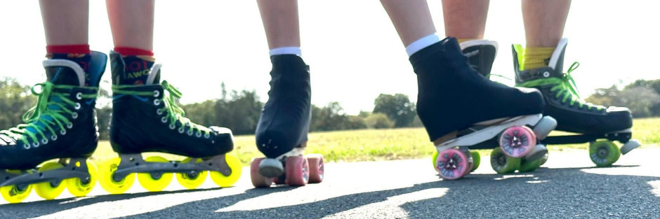 Four pairs of roller skates on a road with a blurred natural background