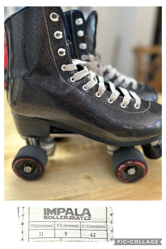 A pair of dark blue glitter roller skates with red wheels and white laces, displayed on a wooden floor. The brand 'IMPALA' is visible on the side.