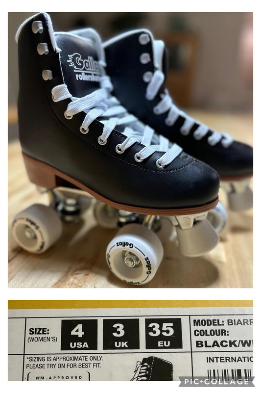 A pair of black roller skates with white laces and wheels, displayed in front of a package with the text 'DS 21cm', indicating the size and color 'Black'.