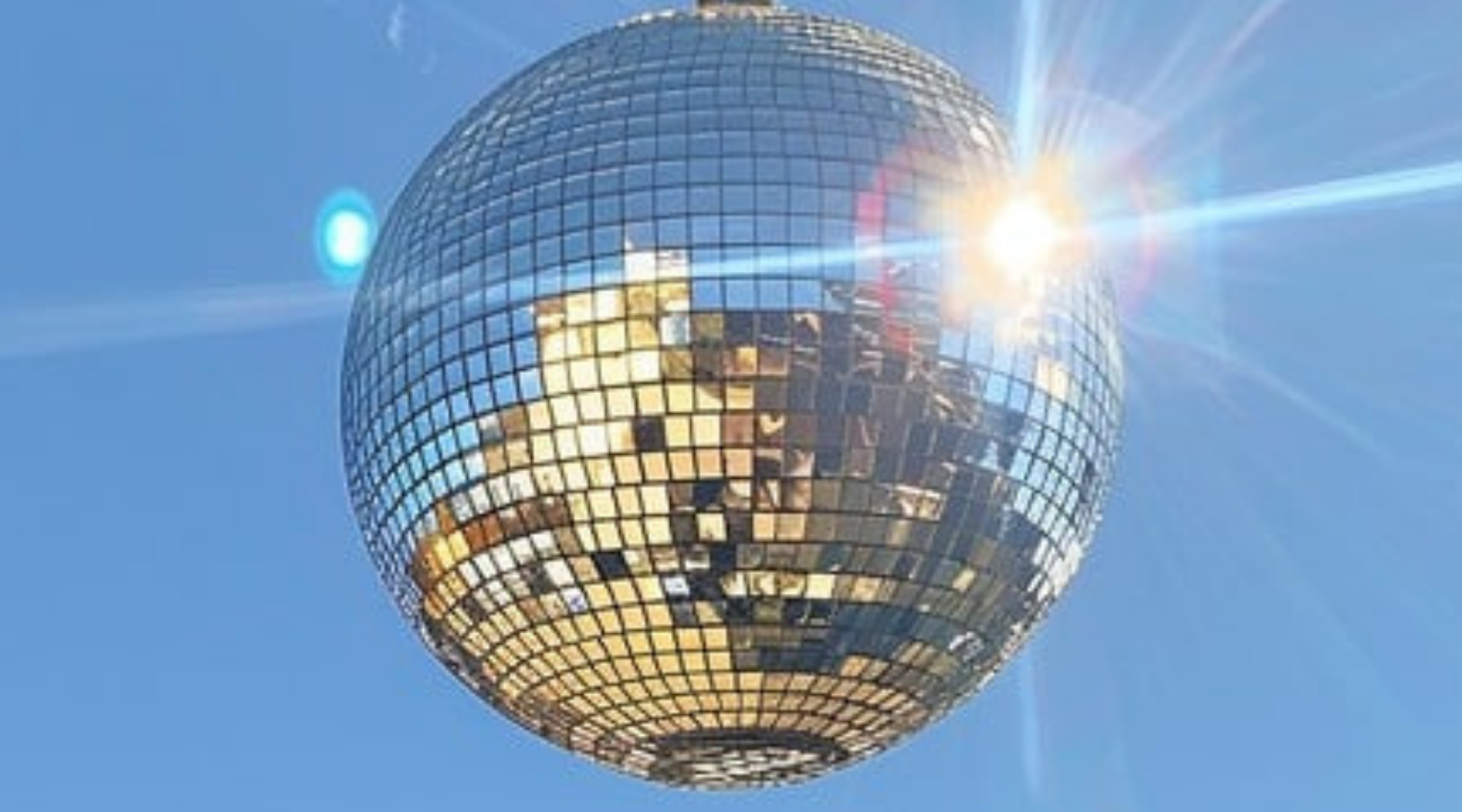 Reflective disco ball against a blue sky with sunlight